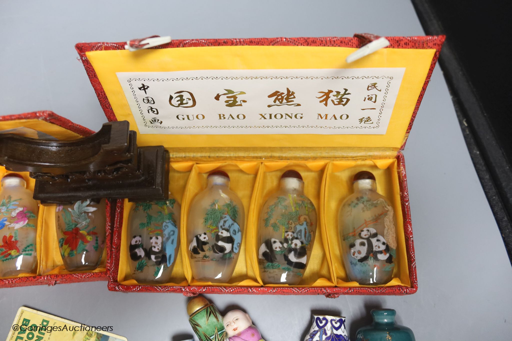 A collection of miscellaneous snuff bottles, figurative carvings, stands etc